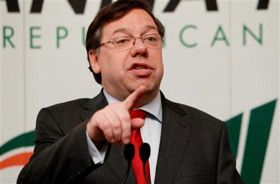 Ireland's Prime Minister Brian Cowen, left, announces his resignation Saturday. 